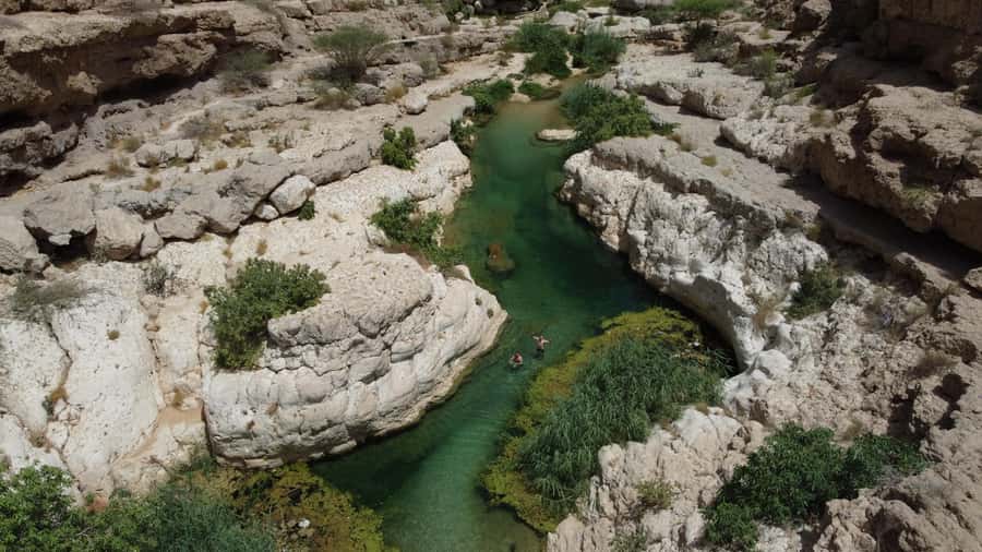 From Muscat: Wadi Shab & Bimmah Sinkhole Full-Day Tour - What to bring (and what to plan for on rocky, wet ground)
