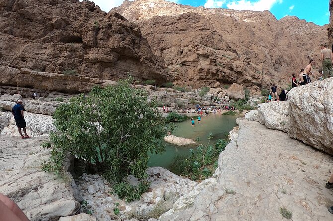 Full-day Private Guided Wadi Shab Tour in Oman - Bimmah Sinkhole after Wadi Shab: clear water and a mountain backdrop