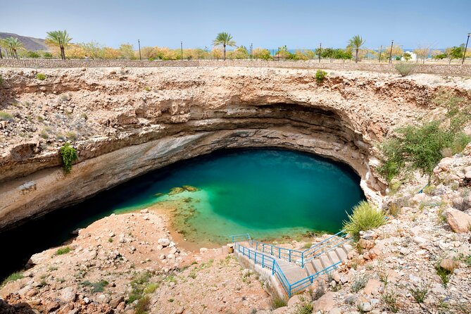 Full Day Tour in Wadi Shab - Bimmah Sinkhole: legs-in fun and photo-ready turquoise water