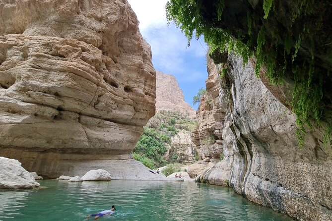 Private Full-Day Wadi Tiwi and Bimmah Sinkhole Tour from Muscat - Fins Beach: white, pebbly, and eye-popping blue water